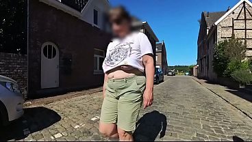 A milf with big saggy tits in the street