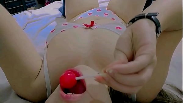 Hot and naughty student sucking lollipops at the bed wearing her new white lingerie and touching herself