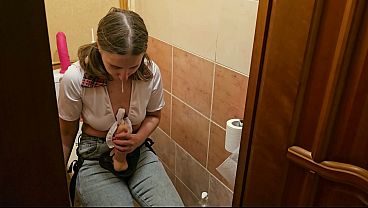 A girl fucks a guy in the ass in the toilet with a strap on