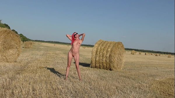 A naked girl moves rollers with hay!