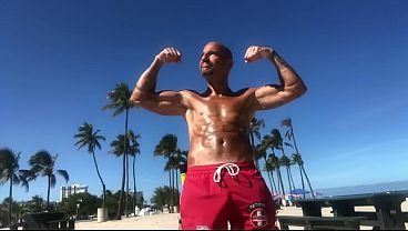 BICEP FLEXING AT THE BEACH