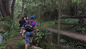 Threesome in the woods with two pretty girls .